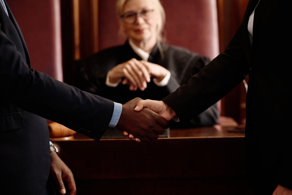 Two people shaking hands over development and planning agreements